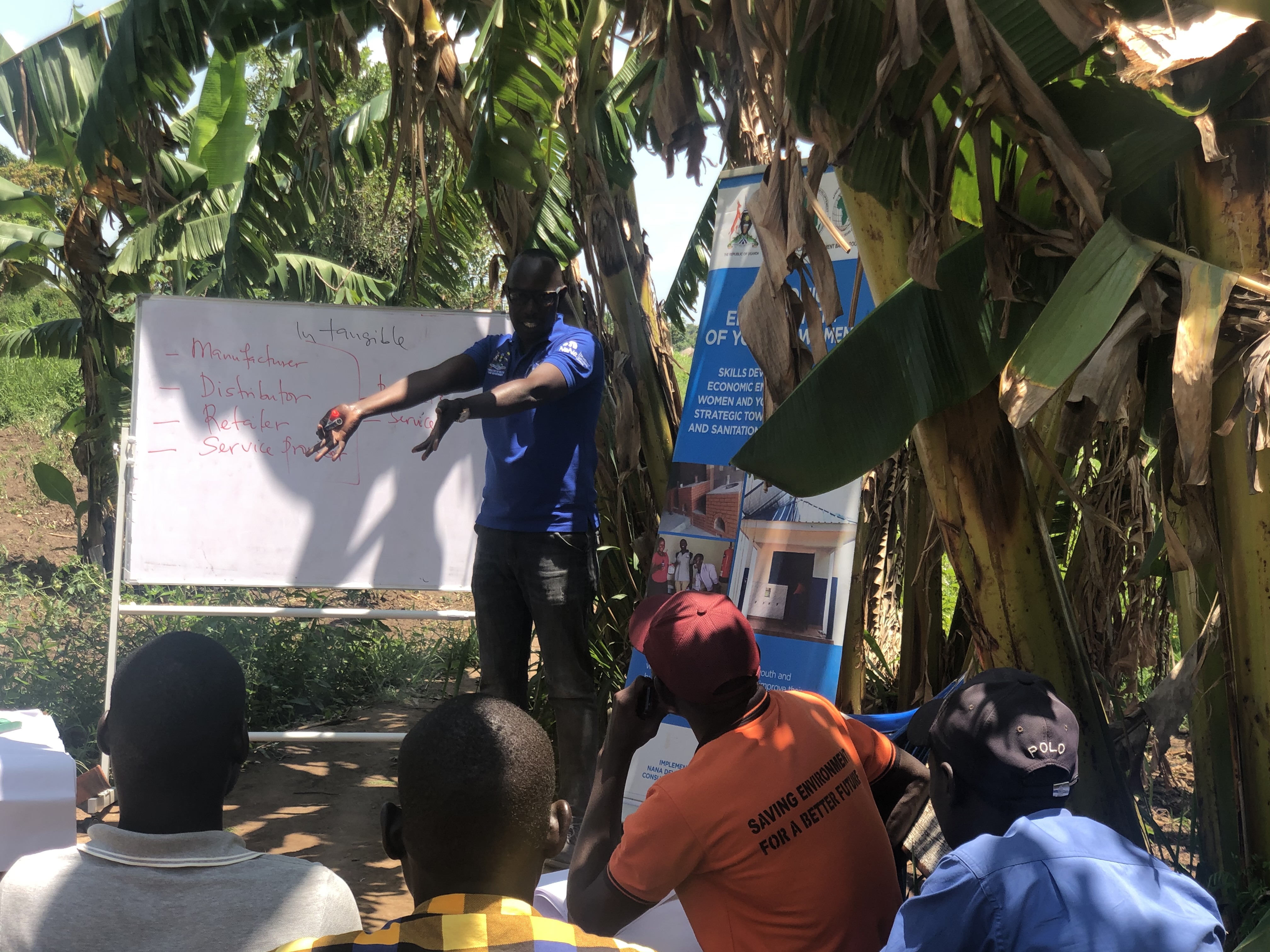 Outdoor community training session under banana trees